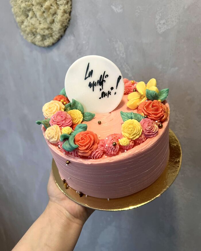 Tort roz cu trandafiri modelați din buttercream